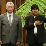 Cuban President Miguel Diaz-Canel and Bolivia's President Evo Morales listen to the Bolivian national anthem at the Revolution Palace in Havana