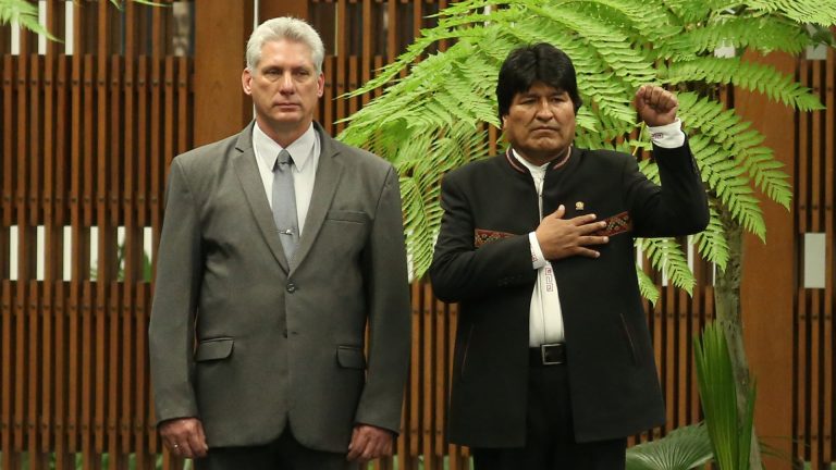 Cuban President Miguel Diaz-Canel and Bolivia's President Evo Morales listen to the Bolivian national anthem at the Revolution Palace in Havana
