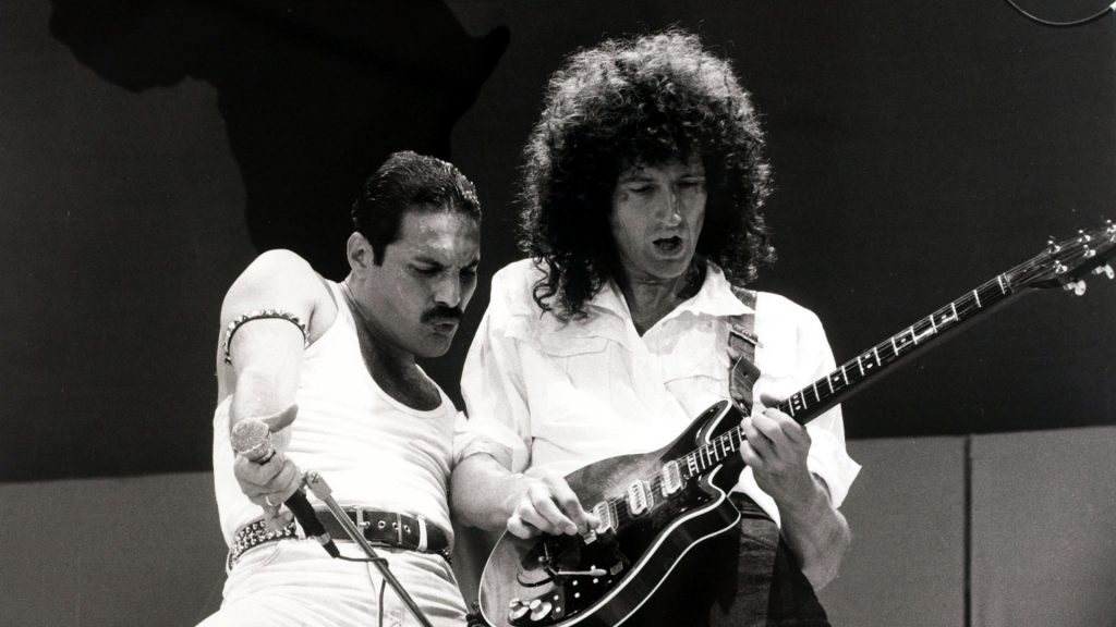 Entertainment/Music. Live Aid Concert. Wembley, London, England. 13th July 1985. British singer Freddie Mercury with guitarist Brian May as "Queen" perform at the charity concert.