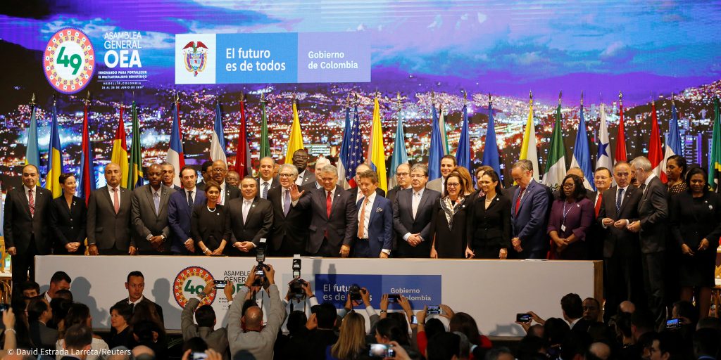 Colombia's President Ivan Duque Marquez greets the audience during the opening ceremony of Organization of American States (OAS) 49th General Assembly in Medellin